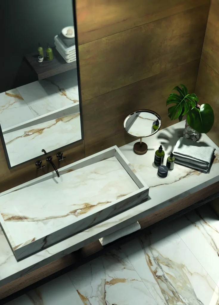 Luxurious bathroom with Calacatta Macchia Vecchia Extreme marble vanity, sink, and floor, featuring bronze wall tiles.