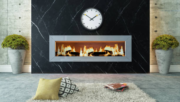 Modern linear gas fireplace set in black marble wall with white veining, flanked by concrete planters in living room