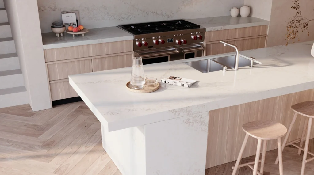 Modern kitchen with white countertops, light wood cabinets, steel range, sink, and island seating.